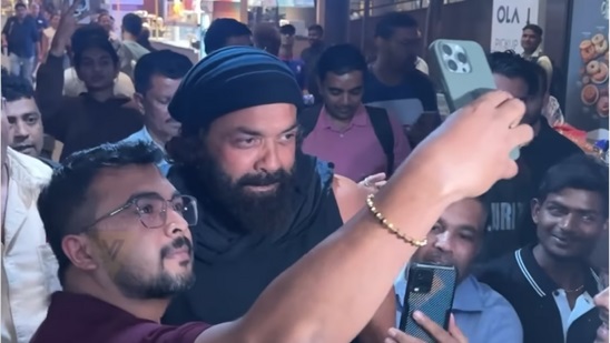 Bobby Deol remains cheerful despite being mobbed by fans at the airport